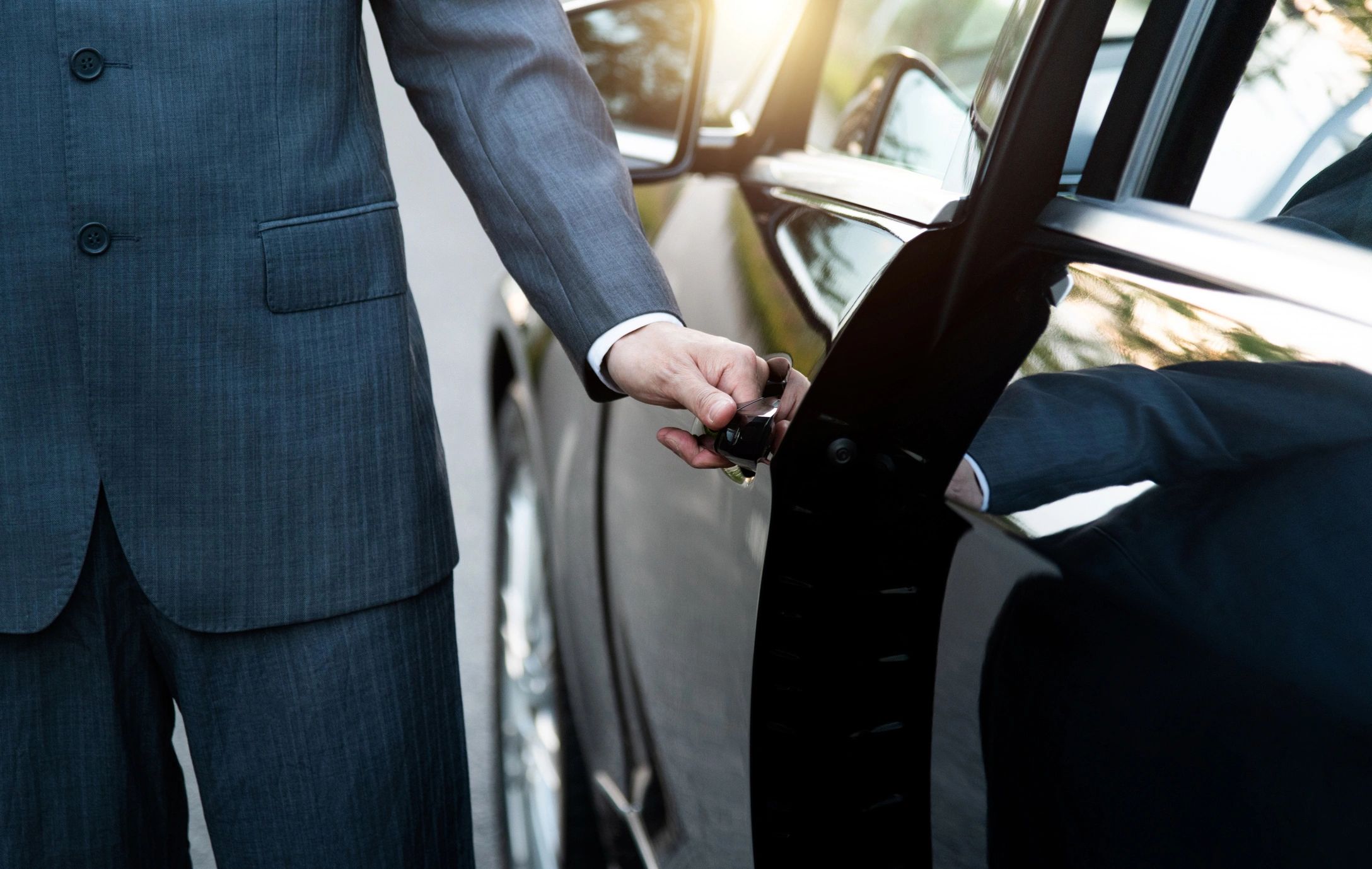 Chauffeur opening Limo door
